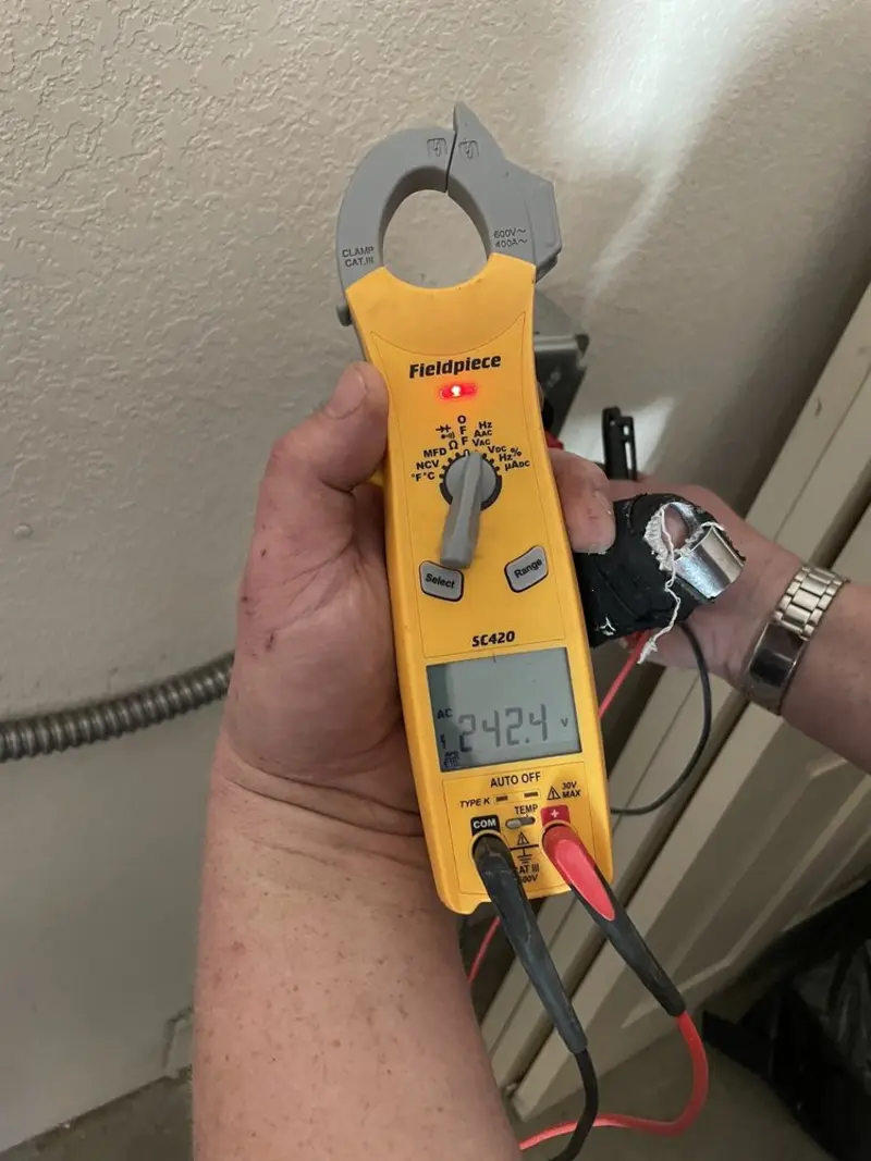 Voltage testing with clamp meter during Ceiling Fan Installation in Bono